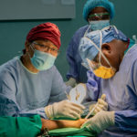 Surgeons performing a procedure on a patient.