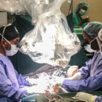 Three people performing surgery